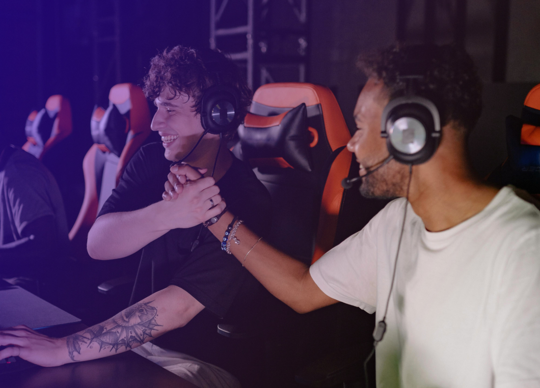 Two guys shaking hands and laughing at their accomplishment 