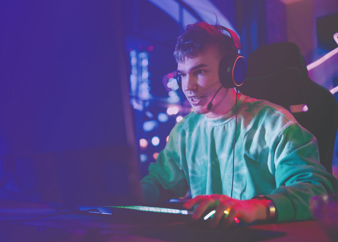 Guy wearing headphones and focusing on his laptop