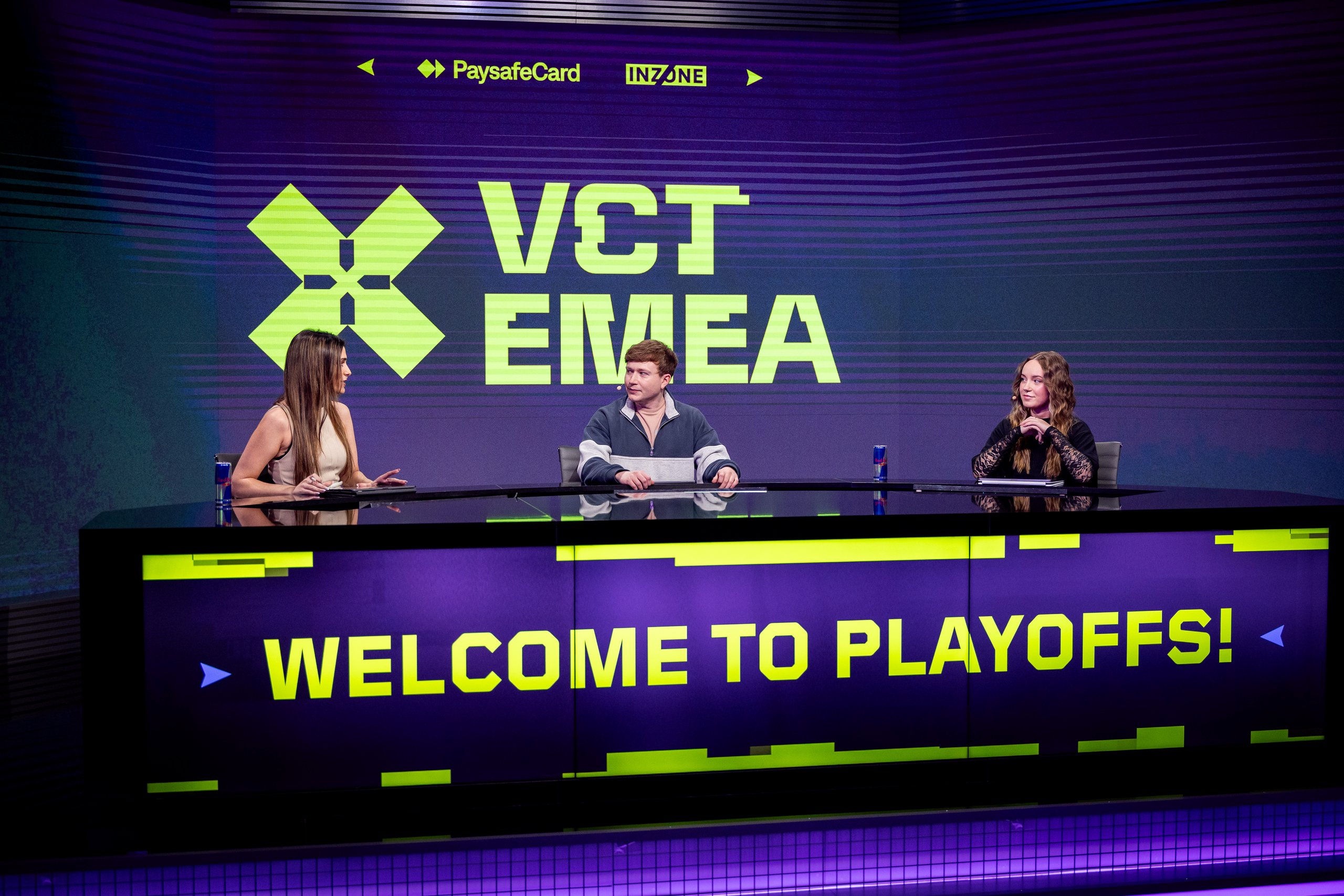 VCT EMEA playoffs desk with three hosts and sponsor logos.