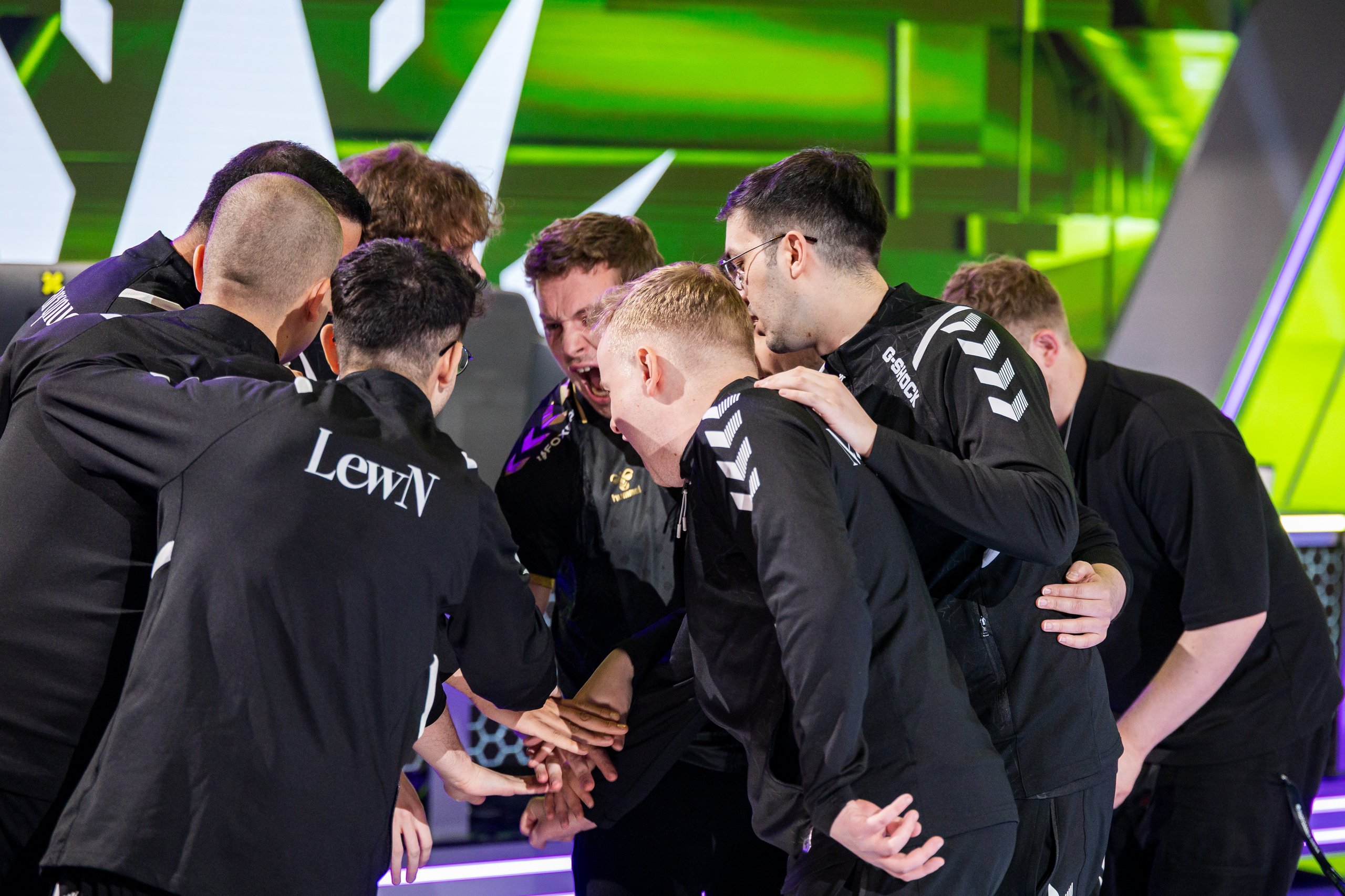 Esports team huddle with hands stacked