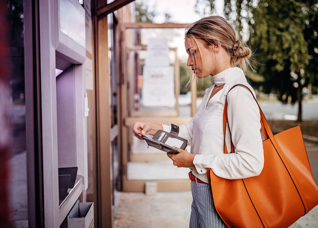 woman withdrawing money from an ATM